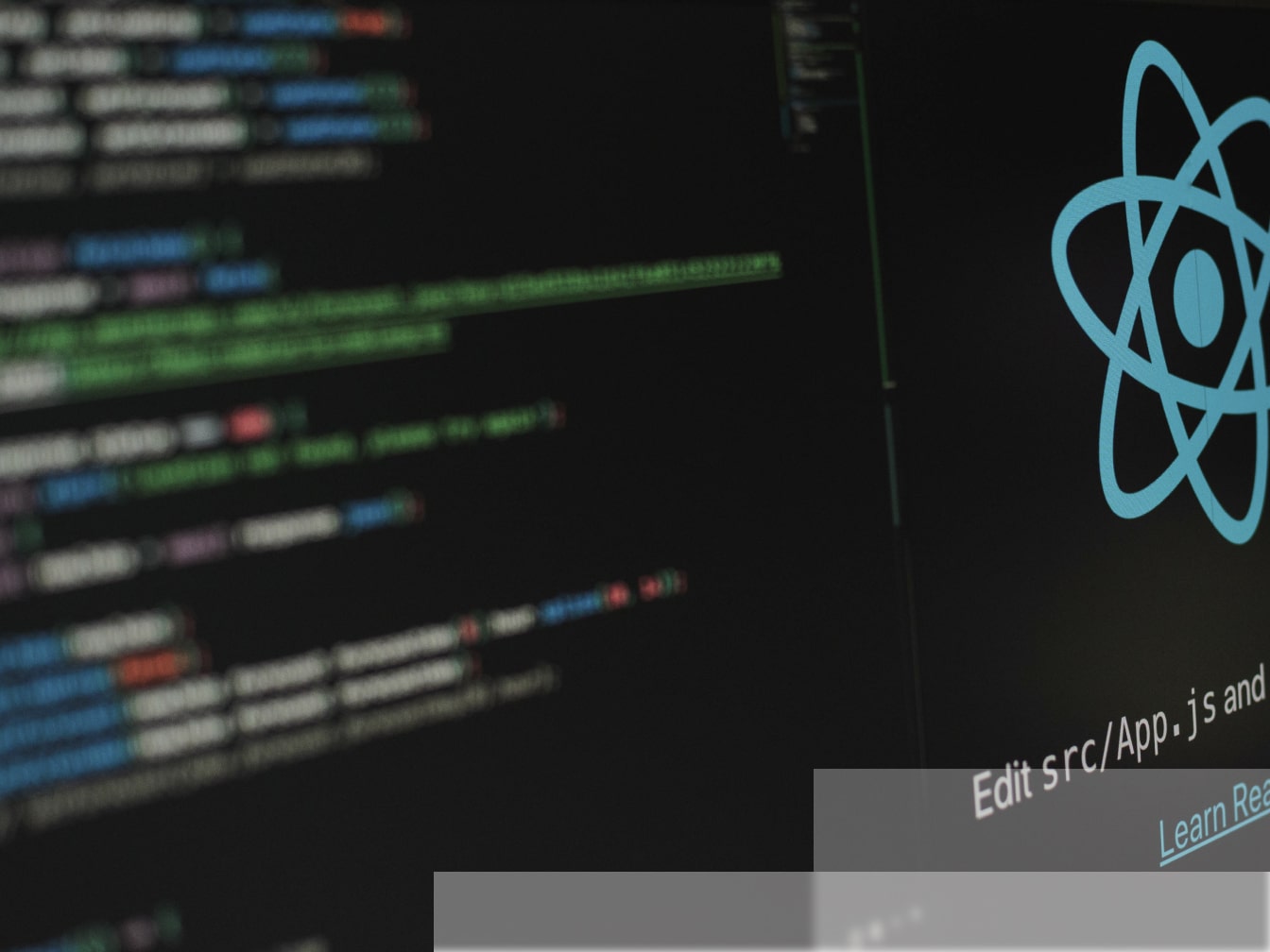 a computer screen with a React logo on it.