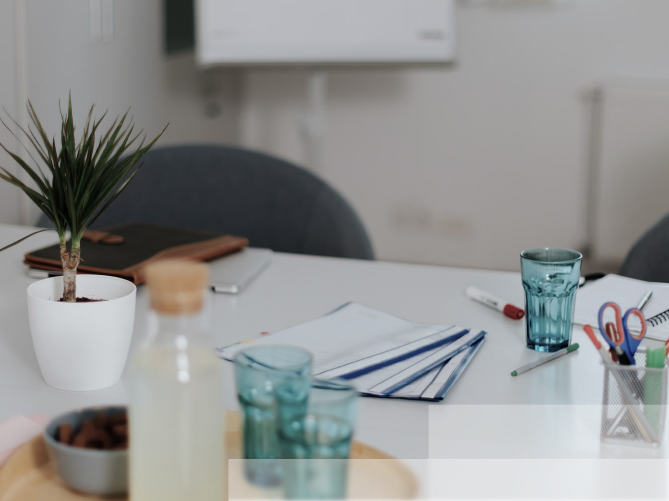 a white table topped with lots of office supplies.
