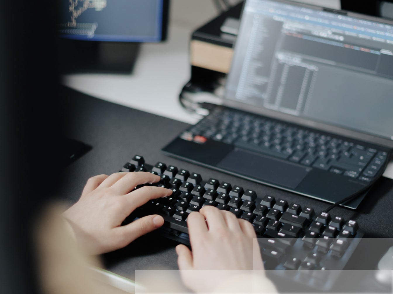 a person is typing on a computer keyboard.